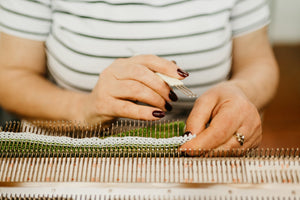 artisan hands working on knitting project